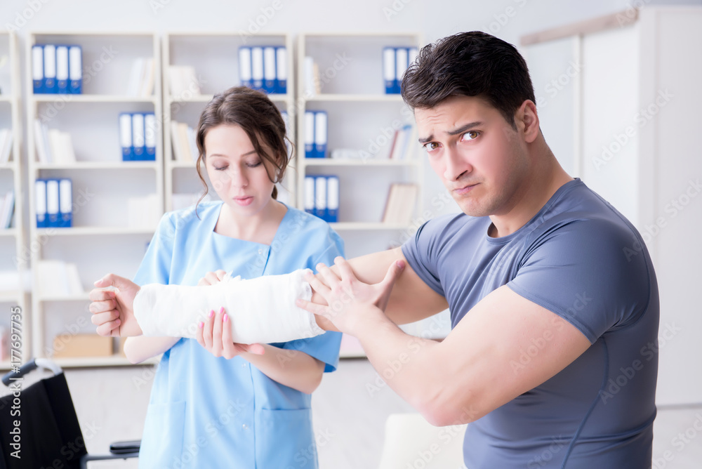 Doctor and patient during check-up for injury in hospital Doctor and patient during check-up for injury in hospital