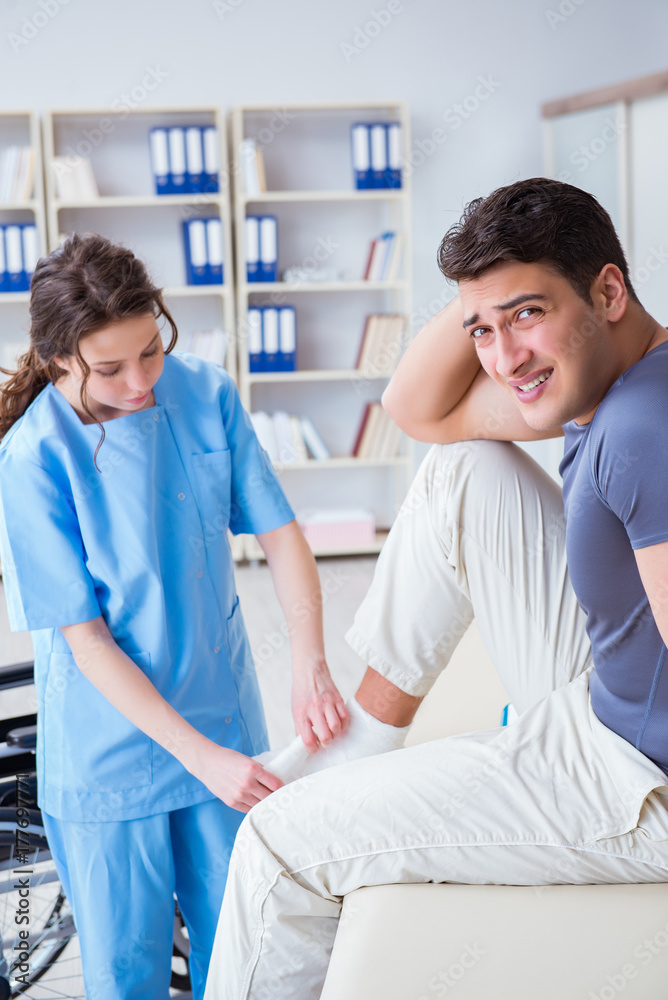 Fototapeta premium Doctor and patient during check-up for injury in hospital