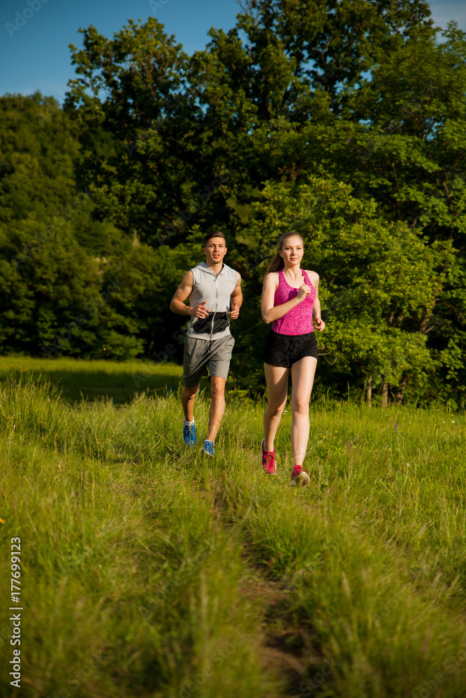 Active young couple running in the park