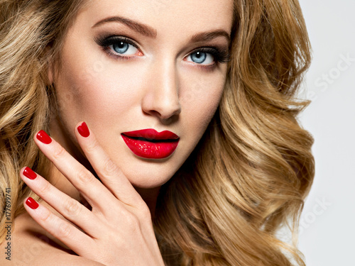 Pretty woman with long hair and red nails