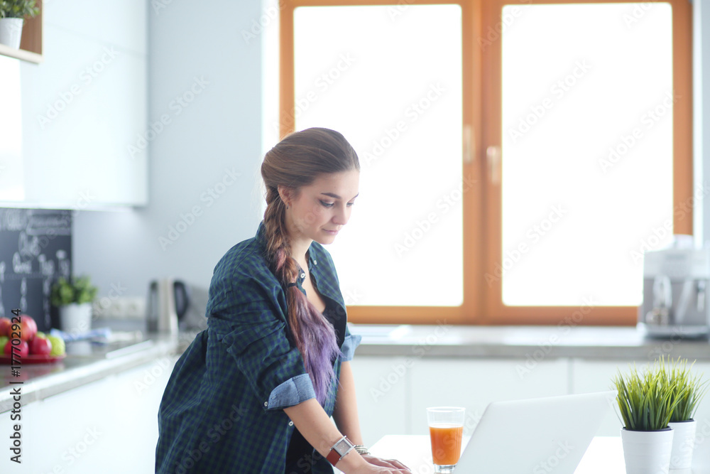 Beautiful young smiling female doctor sitting at the desk and writing. Beautiful young smiling female doctor sitting at the desk and writing.