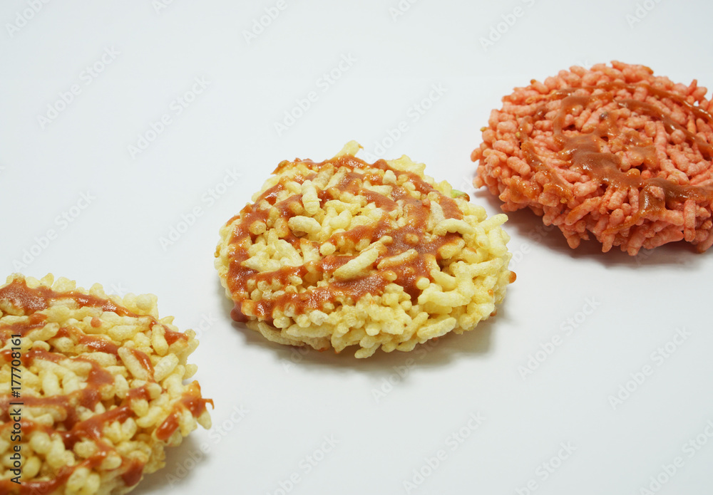 Rice cracker,Thai dessert, on white background. Pink color rice cracker made from herbal coloring. Rice cracker,Thai dessert, on white background. Pink color rice cracker made from herbal coloring.