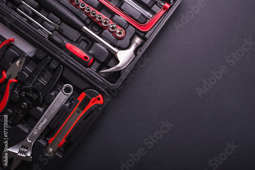 New square black tool box on black granite board background. Composition with free space for text or design