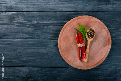 Hot spices Chili and Spice Red Peppers. On a wooden background. Top view. Free space for your text.