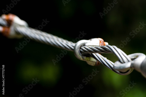 A close up of heavy duty steel wire cable connector. Coils of wire rope or cable used for suspension bridge
