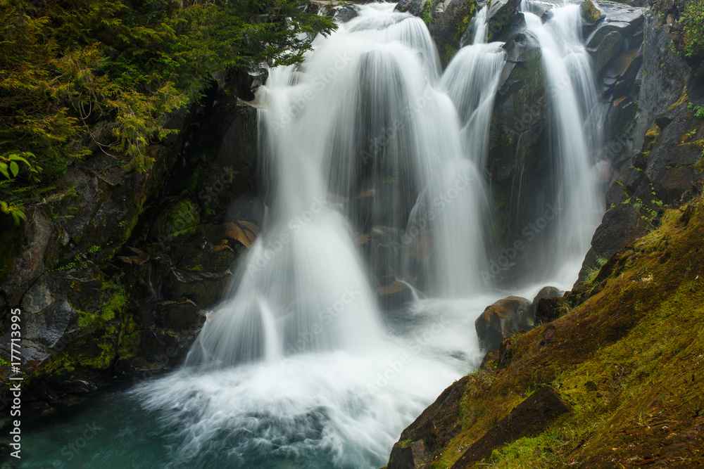 A view of Ruby Falls along Paradise River in Mount Rainier National Park in the summer season. A view of Ruby Falls along Paradise River in Mount Rainier National Park in the summer season.