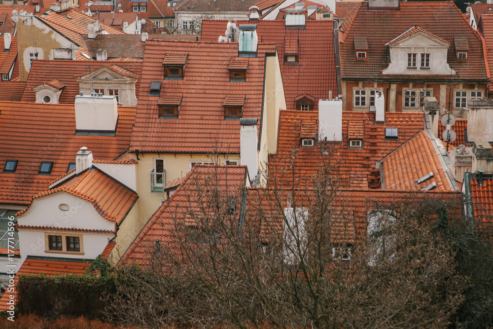 Typical roofs in Prague. Top view - roofs with red tiles in old buildings in Prague. Europe.