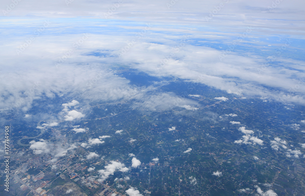 Fototapeta premium Skyline View above the Clouds from air plane. Bird's-eye view.