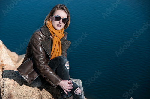 girl on a background of nature and water in autumn