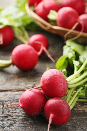 Red radishes on grey wooden table