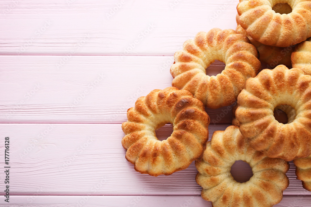 Delicious bundt cakes on pink wooden table