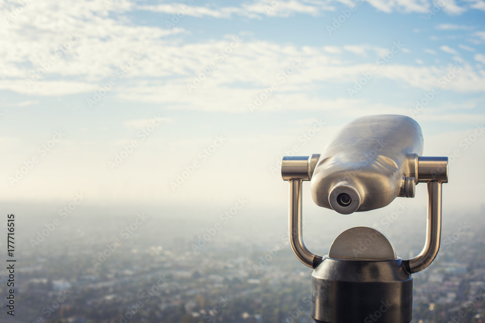 A metal telescope viewfinder overlooking Los Angeles, California
