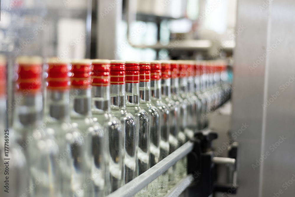 Bottles with vodka on the conveyor. Bottles with vodka on the conveyor.