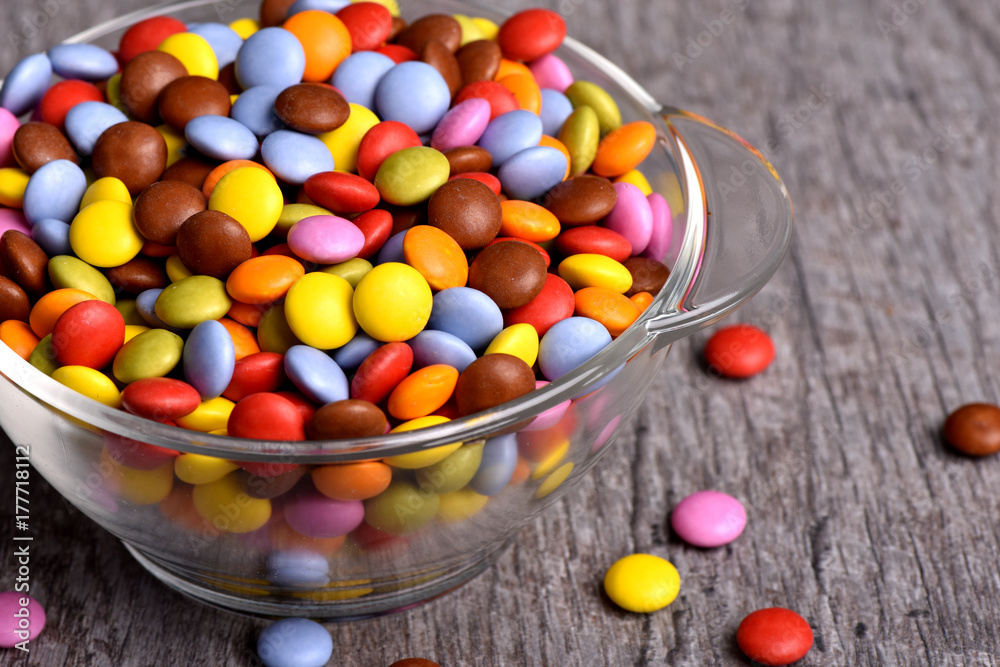 Colored caramels.Confants in a glass vase. Sweetness on a table. Macro of candies. Lollies with a chocolate filling. Colored caramels.Confants in a glass vase. Sweetness on a table. Macro of candies. Lollies with a chocolate filling.