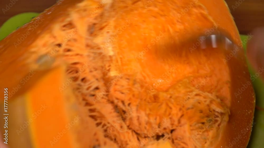 removing seeds from a pumpkin with a spoon removing seeds from a pumpkin with a spoon