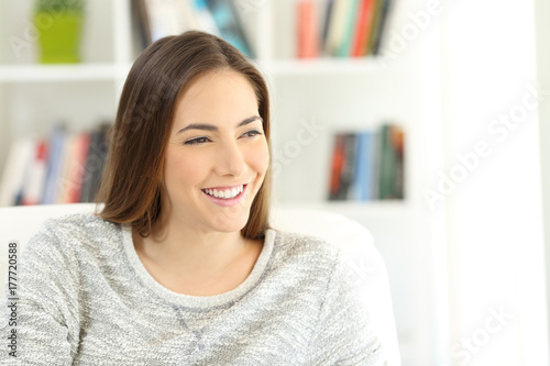 Portrait of a happy pensive woman at home