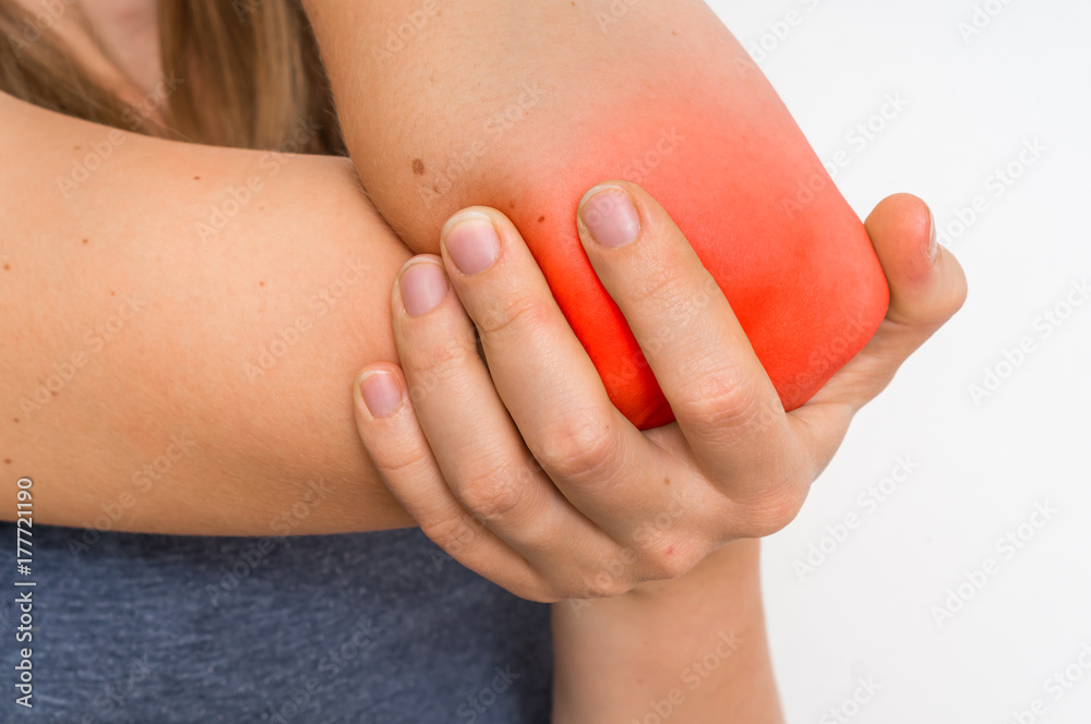 Woman with elbow pain is holding her aching arm Woman with elbow pain is holding her aching arm