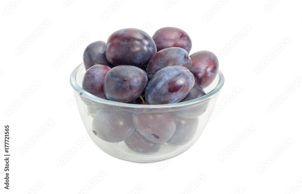 Plums in a glass bowl on a white background Plums in a glass bowl on a white background
