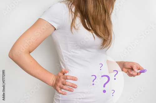 Woman with imagination of a pregnant belly - infertility concept photo