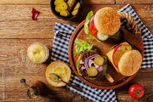 Homemade, beef hamburger with cheese and vegetables.