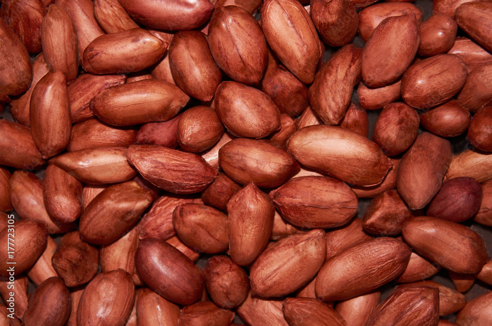 Red grain peanut on the entire background. Food background. Red grain peanut on the entire background. Food background.