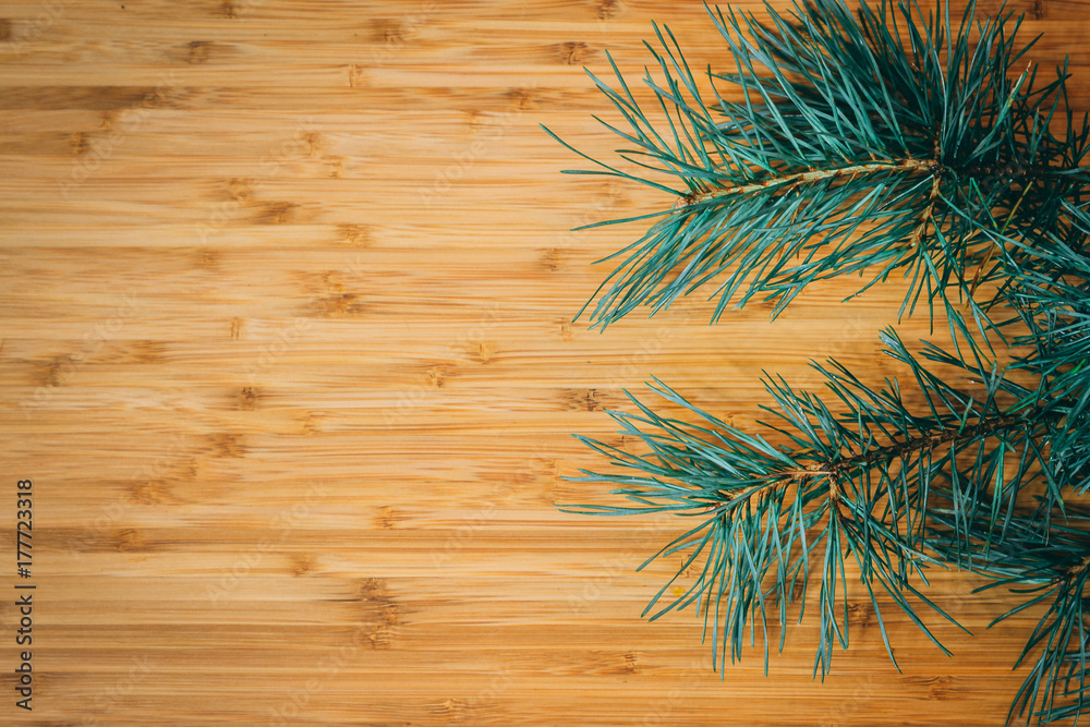 Christmas or New Year composition. Fir branches on wooden background with copyspace for text. Top view, flat. Christmas or New Year composition. Fir branches on wooden background with copyspace for text. Top view, flat.