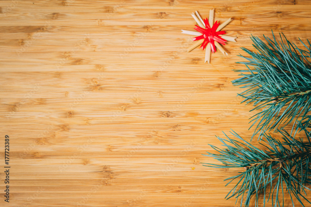 Christmas or New Year composition. Fir branches on wooden background with copyspace for text. Top view, flat.