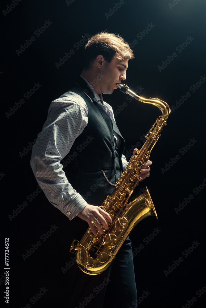 Naklejka premium Young man playing the Saxophone