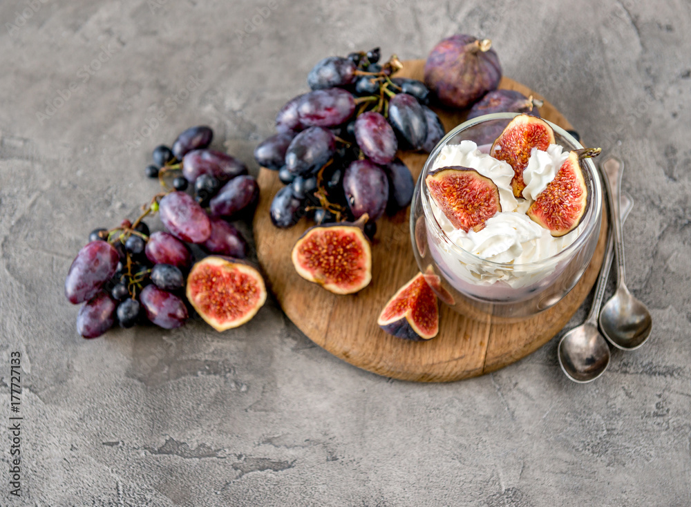 Fototapeta premium An useful dessert - yogurt, muesli and figs with grapes