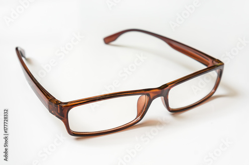 Modern brown eyeglasses isolated on white