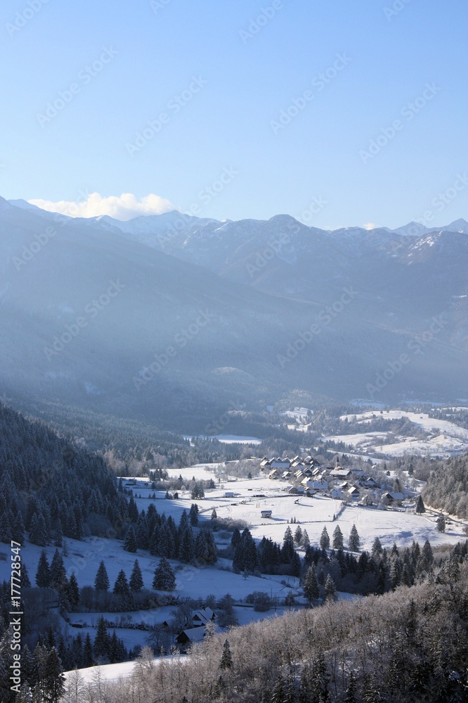 Village Nemški rovt sunlit in winter time Slovenia