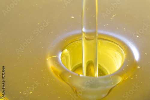 Pouring olive oil with bubbles. photo