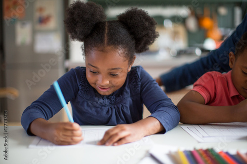 African American girl doing school work at home photo