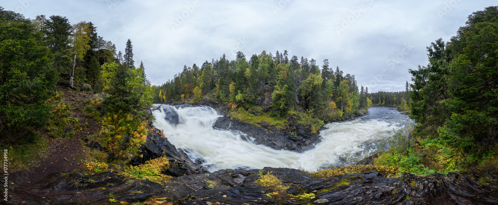 Cliff, stone wall, forest, waterfall and wild river panoramic view in autumn. Fall colors - ruska time in Myllykoski. Karhunkierros Trail, Oulanka National Park in north Finland. Lapland, Europe Cliff, stone wall, forest, waterfall and wild river panoramic view in autumn. Fall colors - ruska time in Myllykoski. Karhunkierros Trail, Oulanka National Park in north Finland. Lapland, Europe
