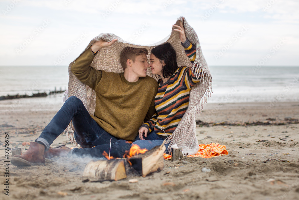 Young couple kissing under a blanket Stock Photo Adobe Stock