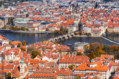 Autumn aerial view of houses and roofs of Prague old city town including Charles bridge. Czech Republic