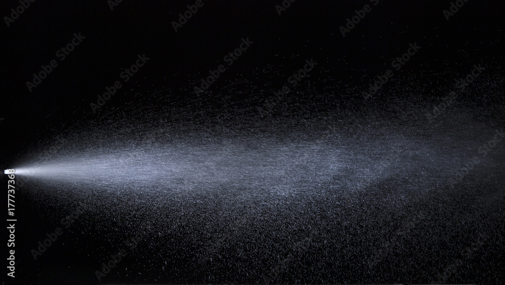 Fotografie Water jet spraying on black background