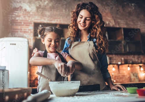 Mom with daughter on kitchen.