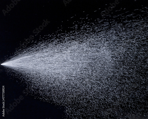 Water jet spraying on black background