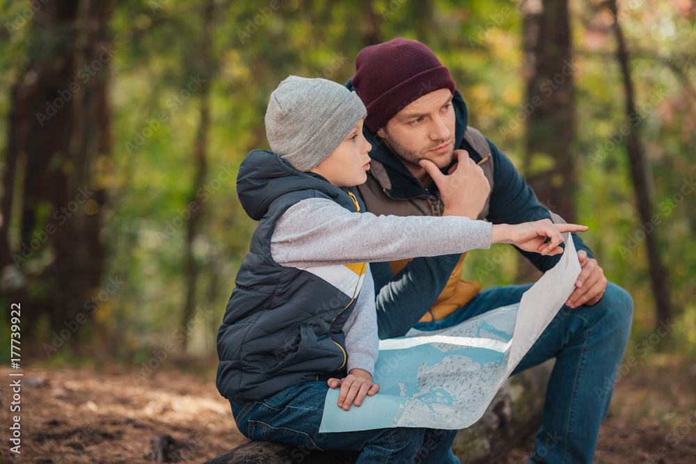 Fototapeta premium father and son with map in forest