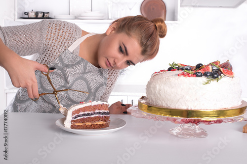 the young hostess cuts cake photo