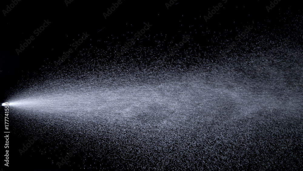 Water jet spraying on black background Water jet spraying on black background