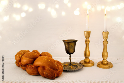 shabbat image. challah bread, shabbat wine and candles on the table photo