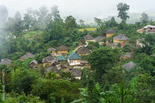 Ethnic minority Ha Nhi village with adobe-style thick-walled houses with mist in Y Ty, Lao Cai province, Vietnam