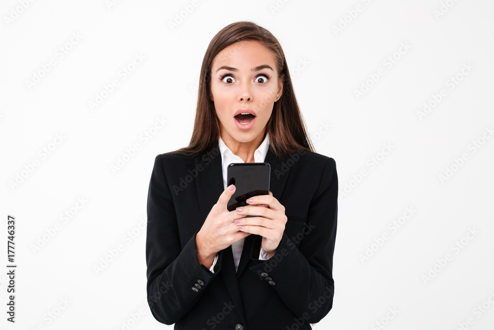 Shocked pretty businesswoman chatting by phone Shocked pretty businesswoman chatting by phone