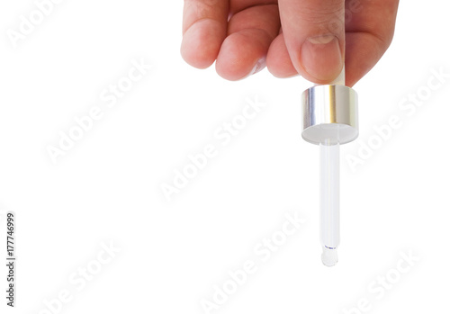 Hand holding a medicine pipette