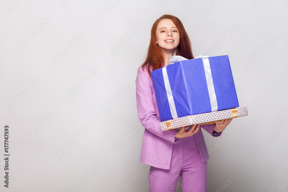Happy birthday! Red haired cute girl holding her gifts and have a happy look. Happy birthday! Red haired cute girl holding her gifts and have a happy look.