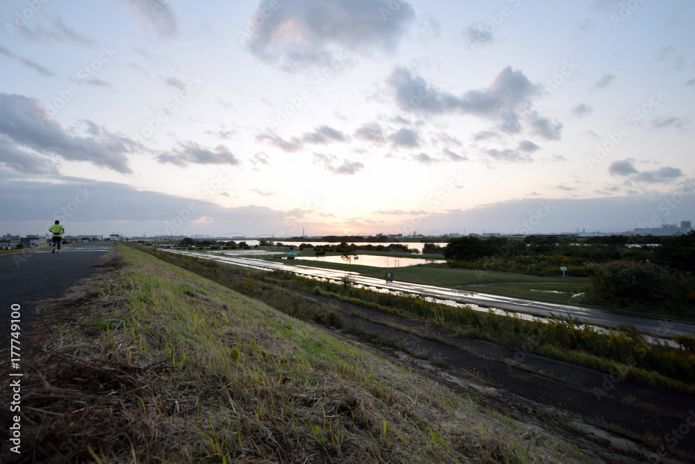 Fototapeta premium A river and the setting sun after the typhoon.