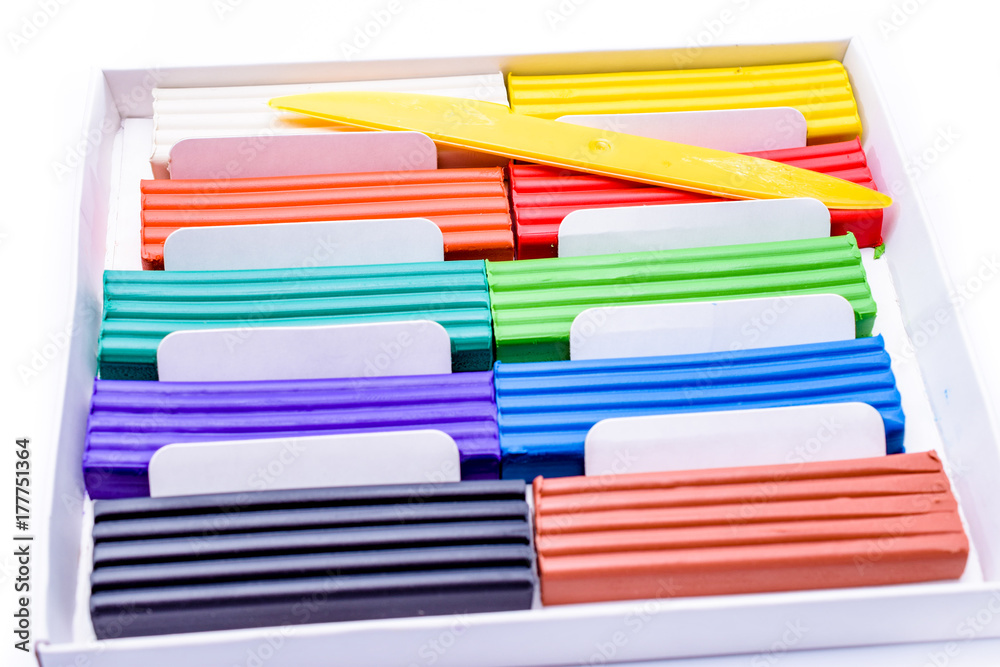plasticine in a box with a plastic knife on white background plasticine in a box with a plastic knife on white background