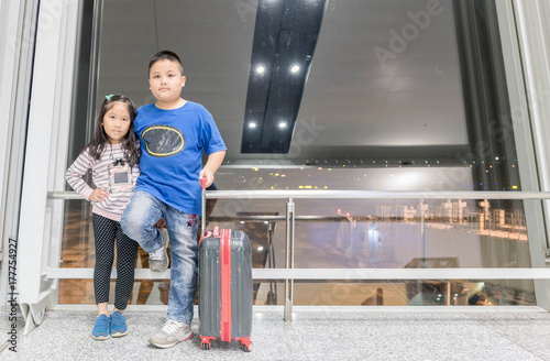 brother and sister standing with baggage © kwanchaichaiudom